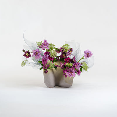 Ceramic vase with a bouquet of flowers on a white background