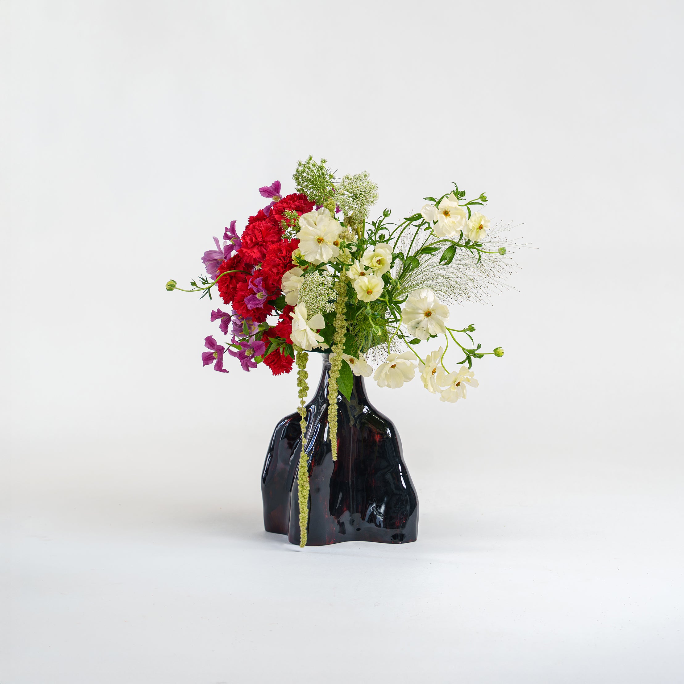 Shop L’Amour a fluid dark vase arrangement with contrasting red and white blooms. A modern art Valentine's gift. Delivery in Dubai.