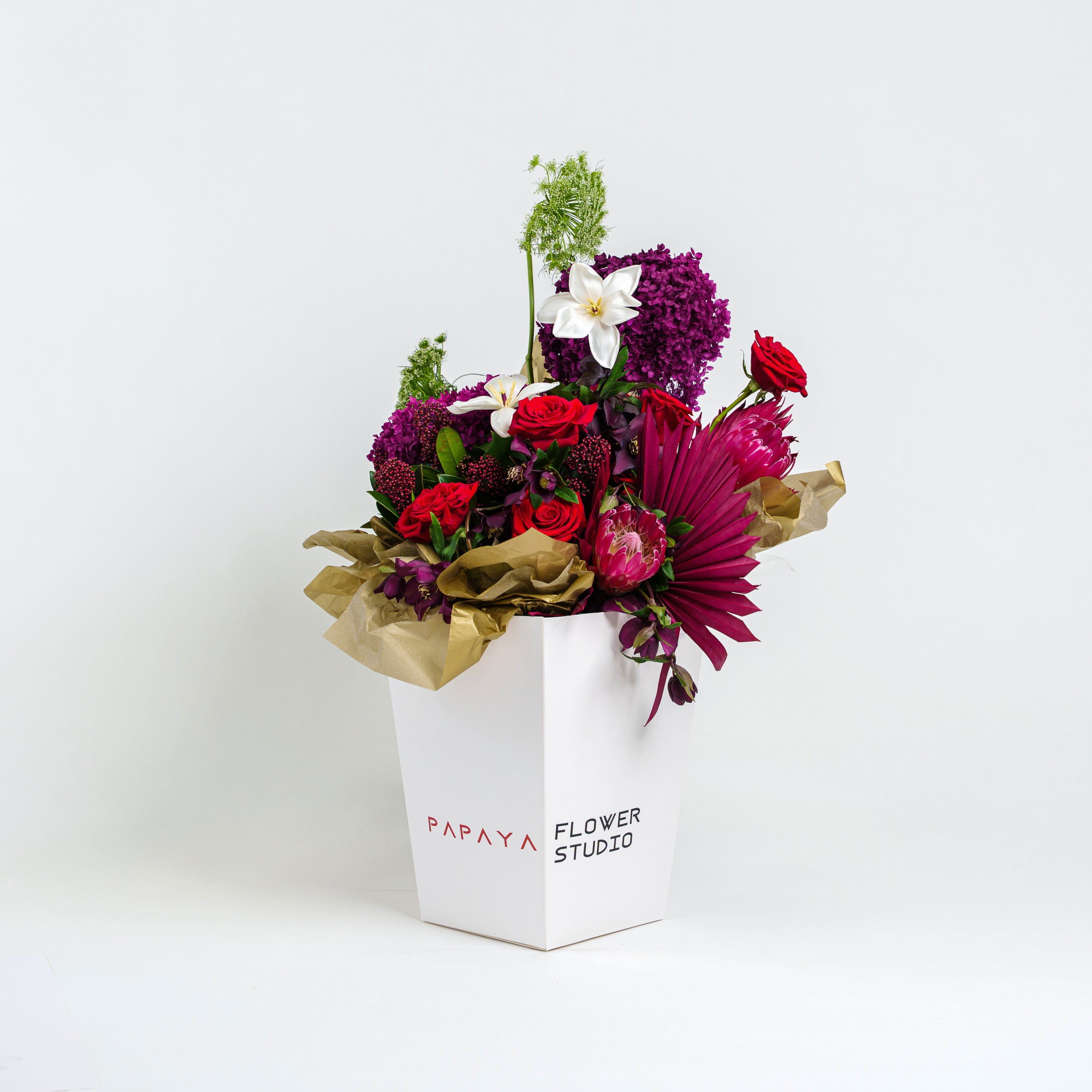 Colorful bouquet of flowers in a white box with 'Papaya Flower Studio' branding on a white background