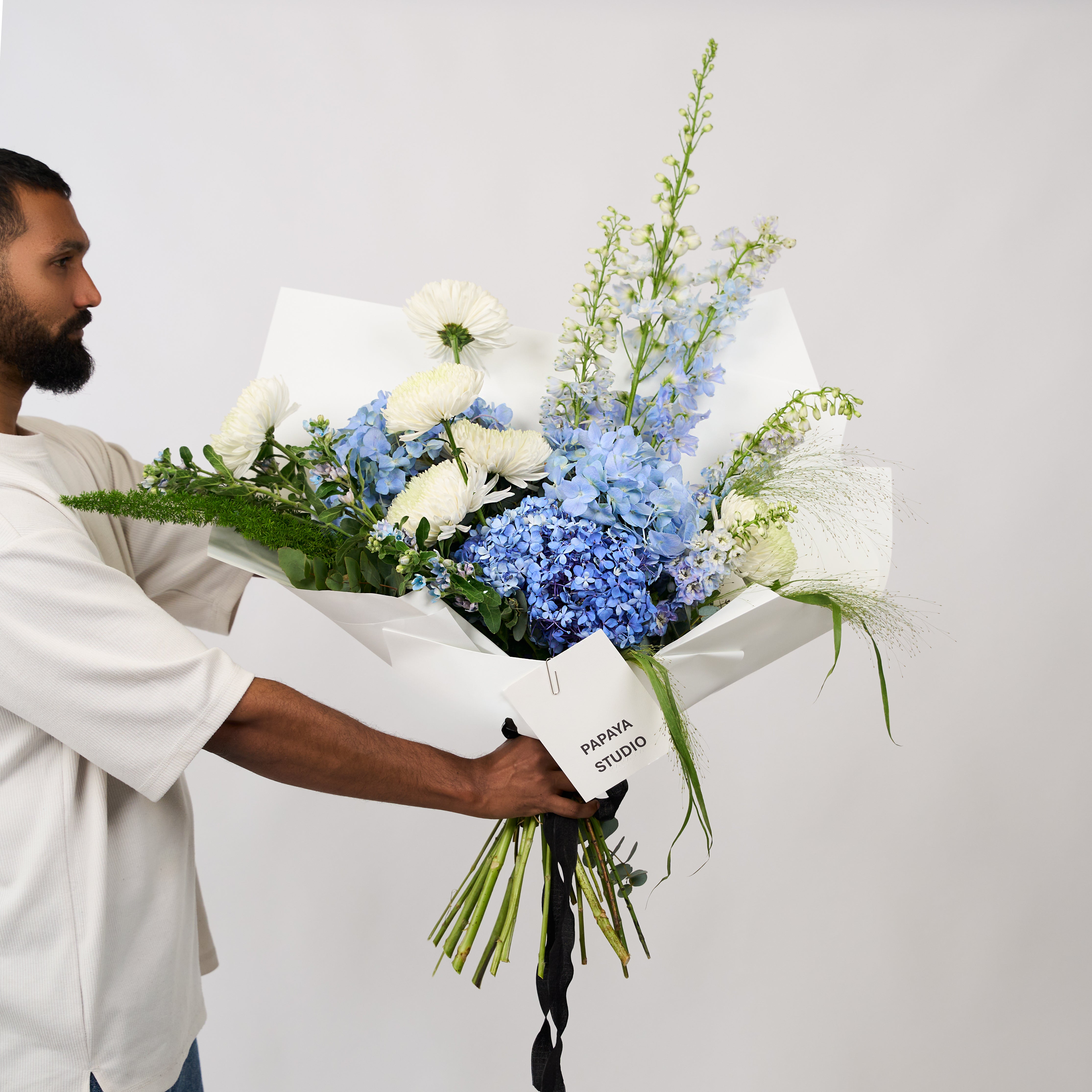 Blue Haven bouquet featuring soft blue hydrangeas, white blooms and fresh greenery.
