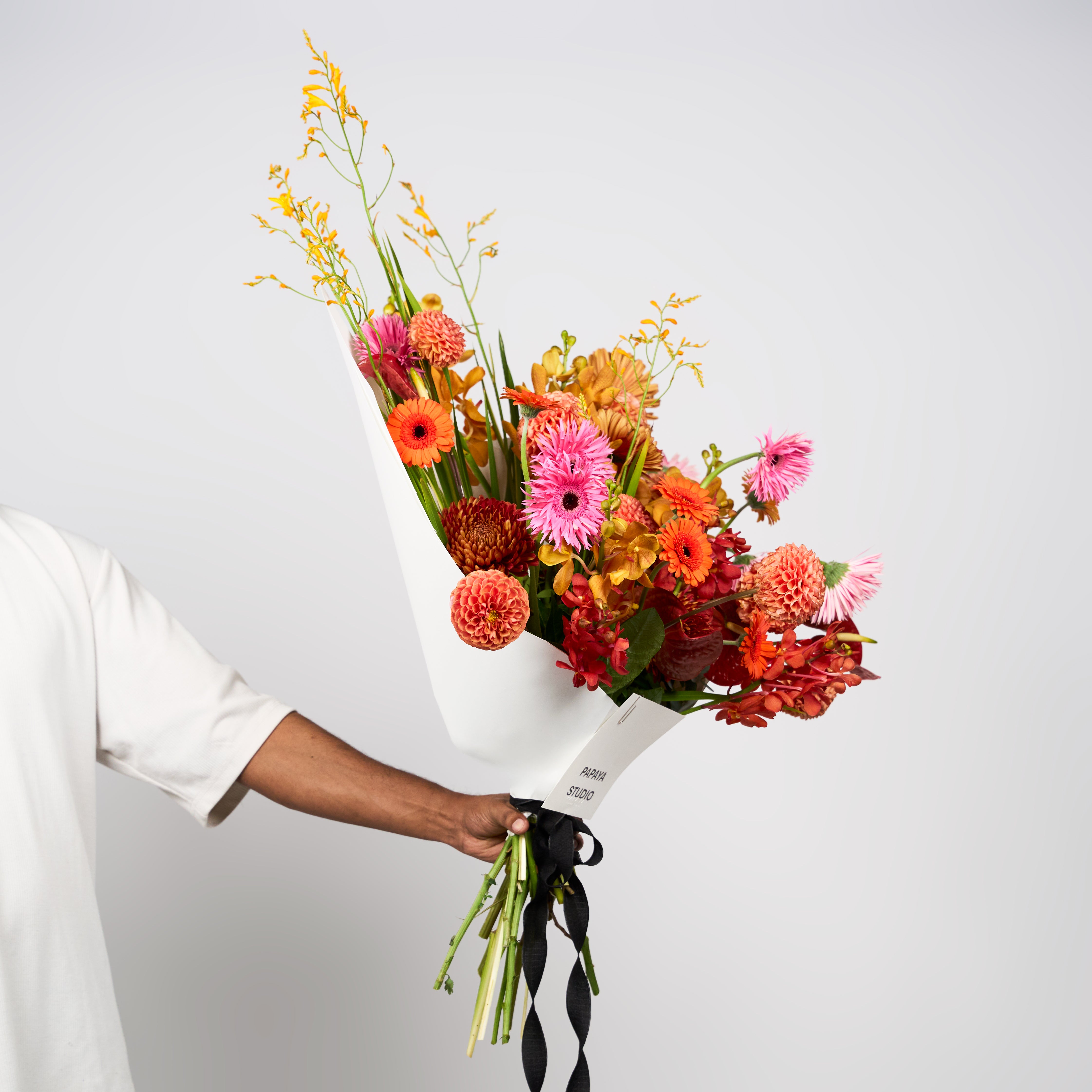 Mixed orange, pink and golden blooms in Papaya Flower Studio’s Saffron Kiss bouquet