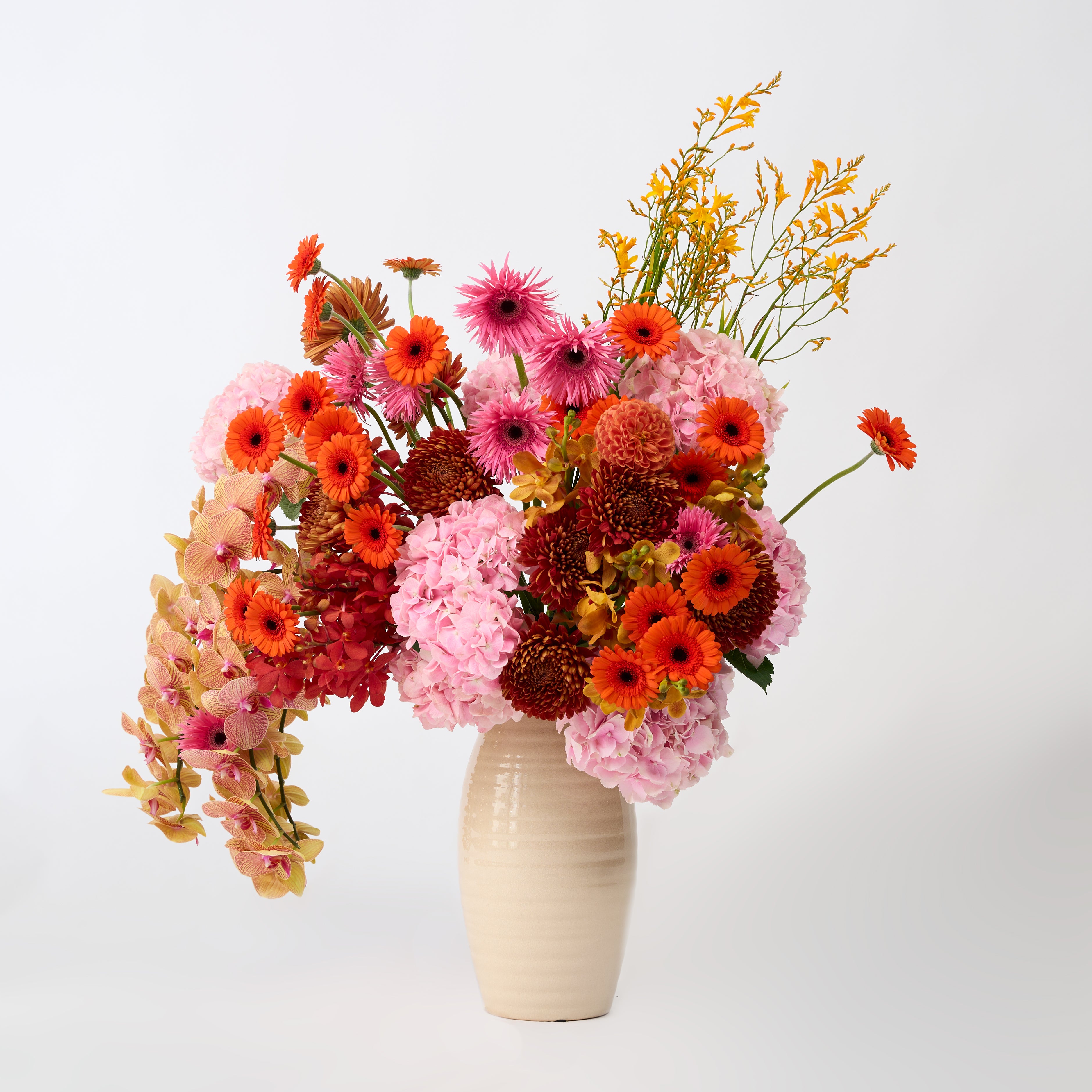 Colourful floral arrangement with pink hydrangeas and orchids in Papaya Flower Studio’s Solara design