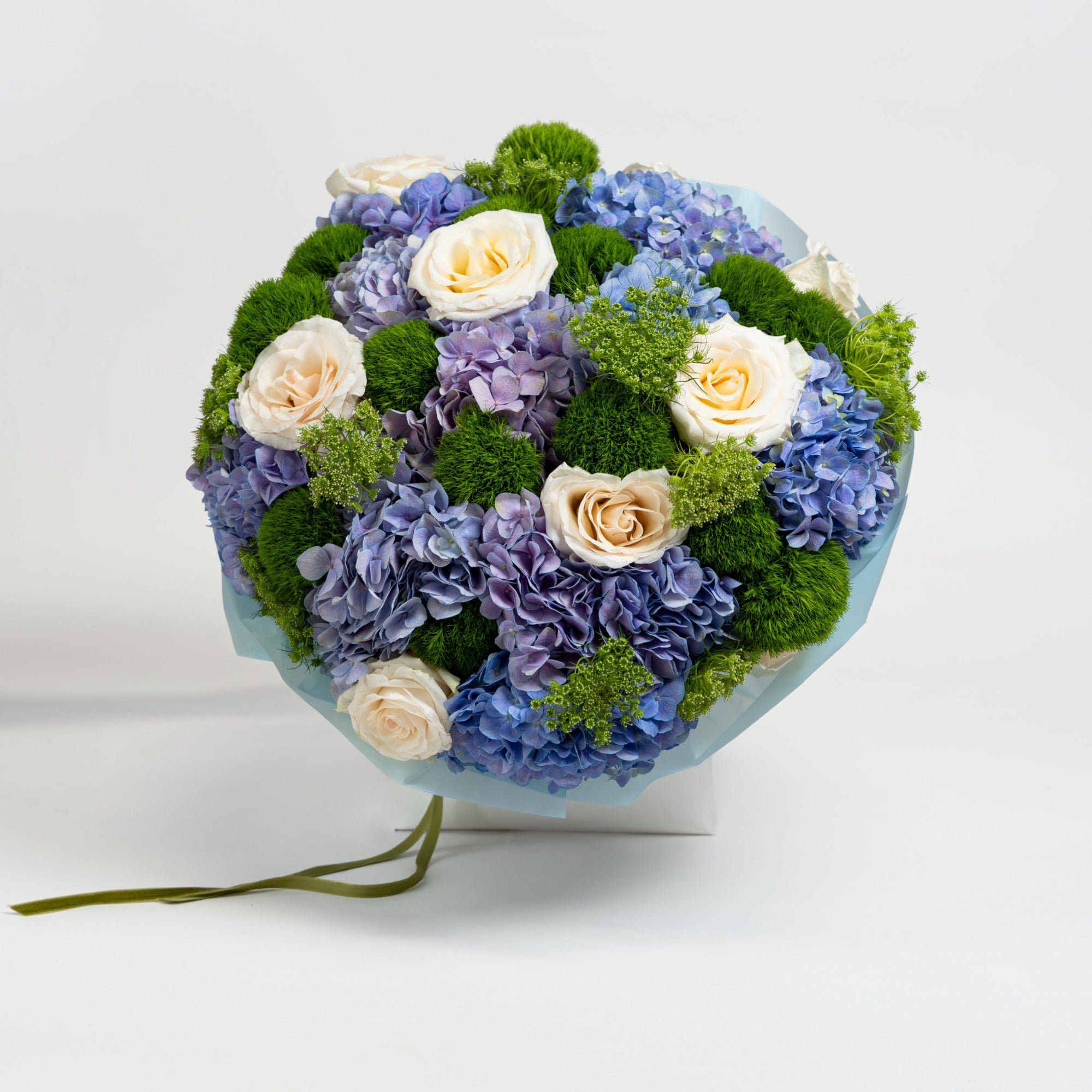 The Azure Reverie blue hydrangea bouquet with ivory roses and Green Trick dianthus by Papaya Flowers