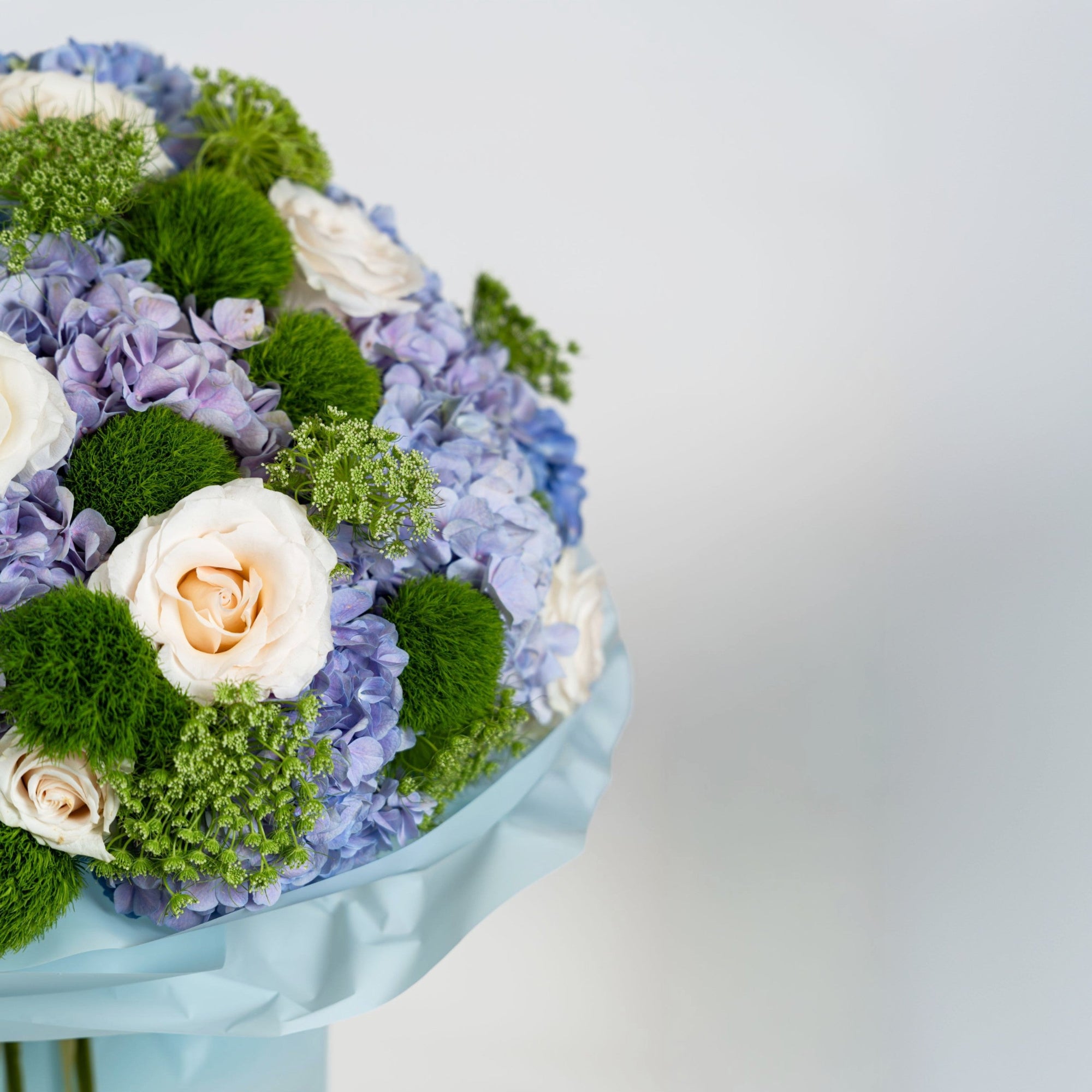 Side detail of The Azure Reverie luxury blue bouquet in powder-blue wrapping