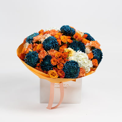 The Cobalt Solstice blue and orange flower bouquet with chrysanthemums and roses by Papaya Flowers