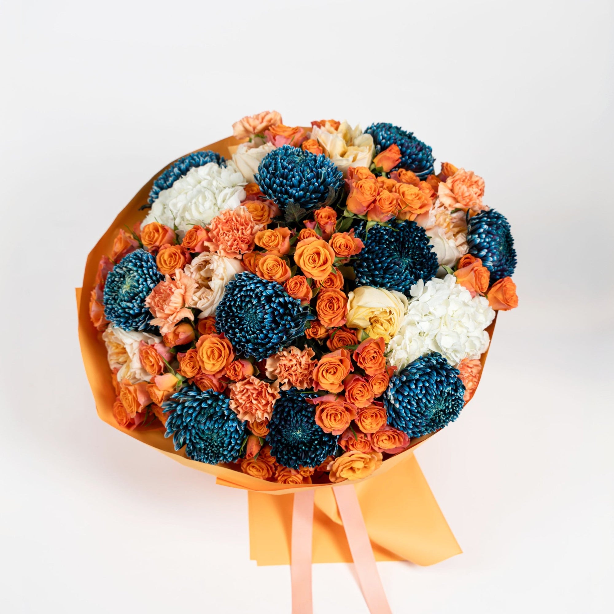 Top view of The Cobalt Solstice with cobalt chrysanthemums, orange spray roses and white hydrangeas