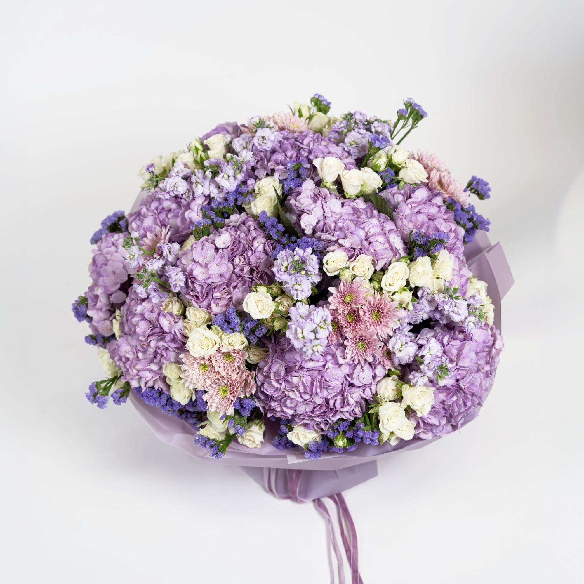 Top view of The Lilac Époque with lilac hydrangeas, ivory spray roses and blush chrysanthemums