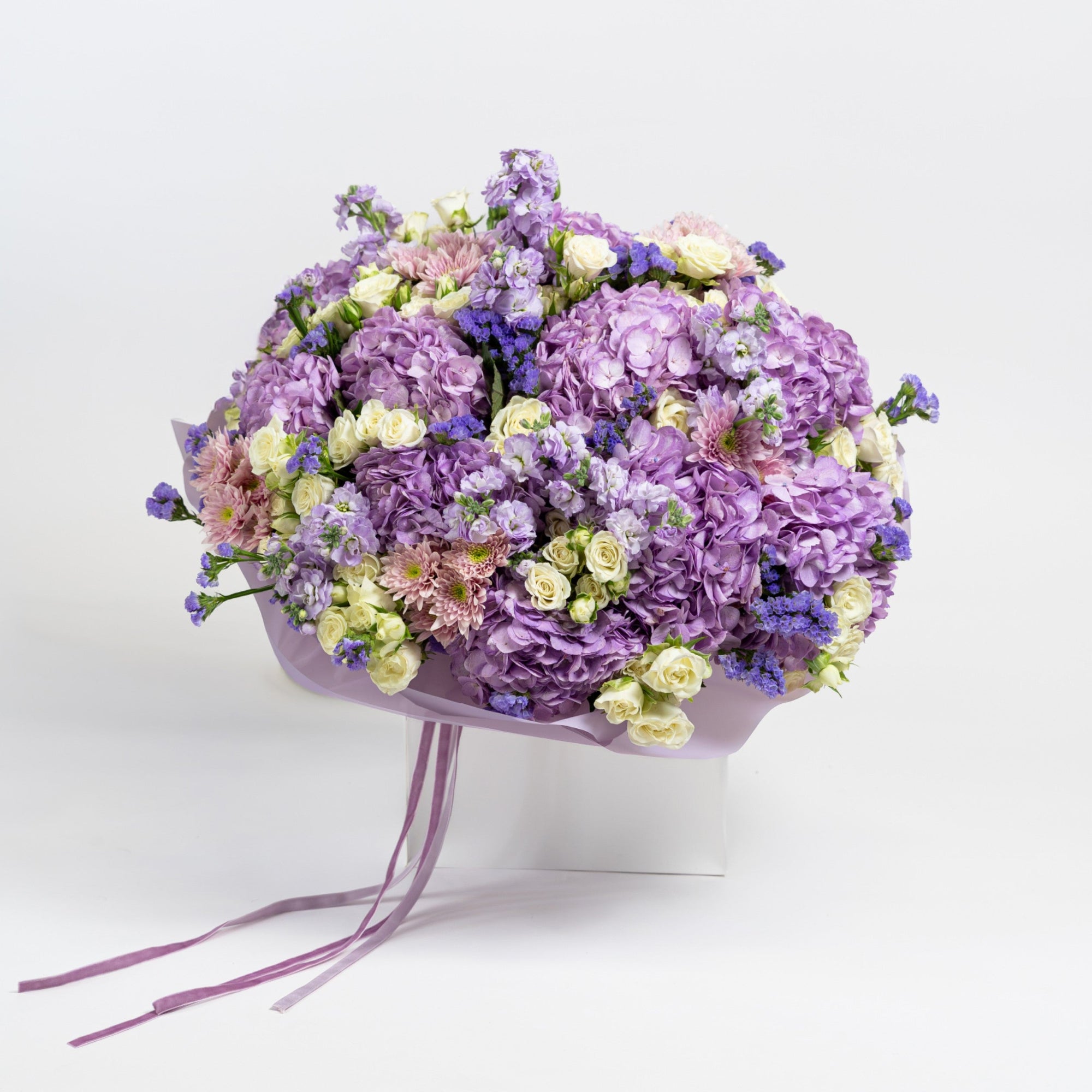 The Lilac Époque purple hydrangea bouquet with ivory spray roses by Papaya Flowers